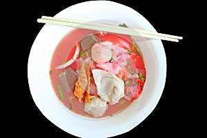 Authentic Thai-style noodle soup with fishballs, crispy wonton skin, and special homemade red sauce