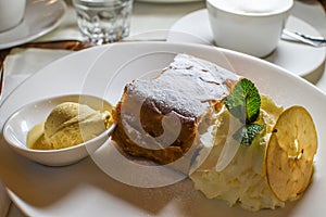 Authentic traditional apple strudel, Apfelstrudel in Vienna, Austria. Served on a white plate