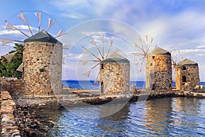 Traditional old windmills over sunset,Chios island,Greece.