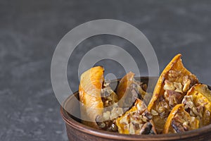 Authentic view of the baked sliced pumpkin with honey and walnut