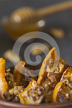 Authentic view of the baked sliced pumpkin with honey and walnut