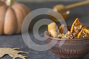 Authentic view of the baked sliced pumpkin with honey and walnut