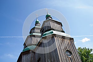 Authentic wooden Slavic Orthodox church against the sky and trees