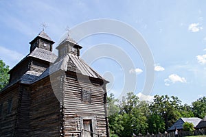 Authentic wooden Slavic Orthodox church against the sky and trees