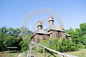 Authentic wooden Slavic Orthodox church against the sky and trees