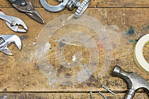 Authentic worn workshop bench background with various tools