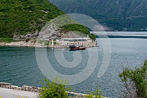 Authentic yacht sails past Verige 65 in the bay on a background of mountains photo