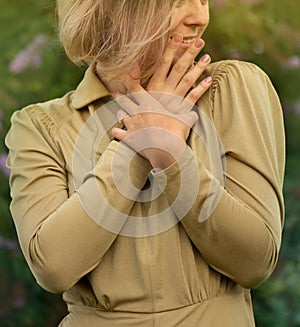 Authenticity emotions concept. Cheerful young woman smiling and enjoying nature near the buddleia flowers