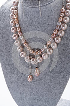 author beautiful jewelry with natural pearls demonstrated around white backround. fashion and jewelry concept