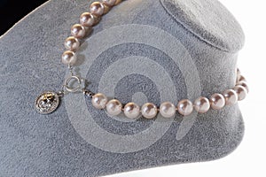 author beautiful pearls necklaces demonstrated on maneken. fashion and jewelry concept photo