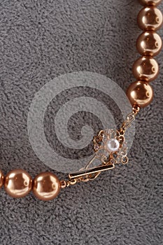 Author handmade golden  pearls necklace presented on maneken. fashion and jewelry concept. macro shot