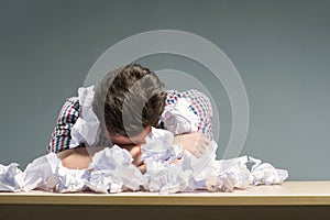 Author lying in the heap of paper