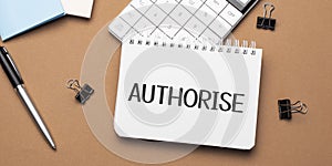 AUTHORISE on notepad with pen, glasses and calculator