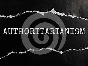 AUTHORITARIANISM text title on black torn paper background
