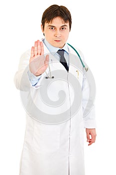 Authoritative medical doctor showing stop gesture
