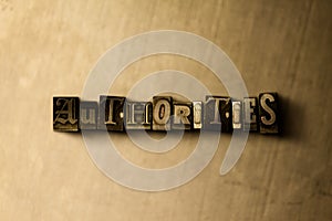 AUTHORITIES - close-up of grungy vintage typeset word on metal backdrop