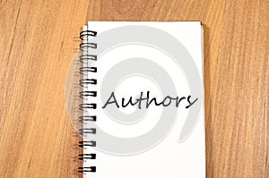 Authors write on notebook