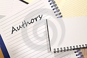 Authors write on notebook