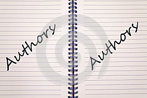 Authors write on notebook