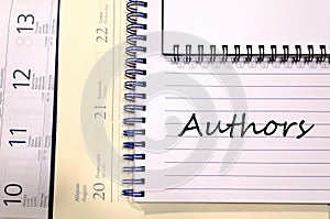 Authors write on notebook