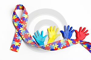 Autism awareness concept with colorful hands on white background. Top view photo