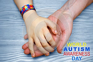 Autism Awareness Picture. Father holding hand his autistic child