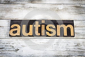 Autism Letterpress Word on Wooden Background