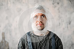 Autist with stretch film on head, autism