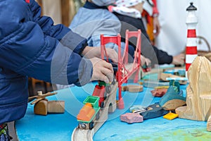 Autistic boy playing with toy car on wooden table