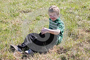 Autistic Boy Sitting in a Field