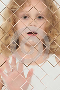 Autistic Child Blurred Behind Pane Of Glass