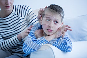 Autistic child lying on sofa