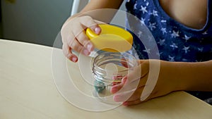 Autistic child unscrews and spins the can lid