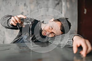 Autistic man pours water from the glass on table photo