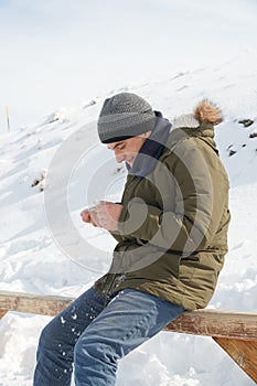 Autistic teenage boy exploring snow