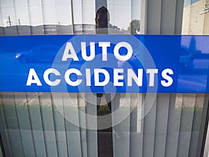 Auto Accident Sign In a Window of a Business