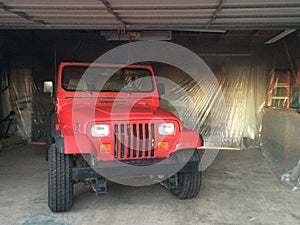 Auto Body Repair and Repainting Prep Work on Red Vehicle