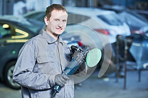Auto mechanic with buffing machine photo