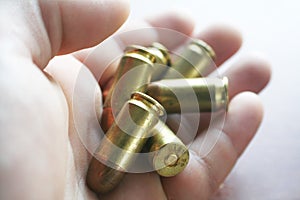 45 Auto Bullets In Hand Close Up High Quality