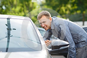 Auto business, car sale, consumerism and people concept - happy couple buying car in auto show or salon