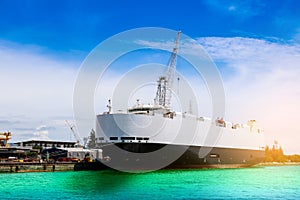 Auto car carrier ship moored in the sea blue