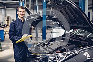 Auto car repair service center. Mechanic examining car engine