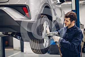 Auto car repair service center. Mechanic at work