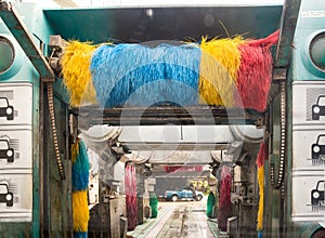 Auto car wash machine spray soapy water to the car in the washing process.