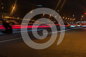 Auto, city street lights and speed. Abstract blurred colorful background of urban street night traffic with bokeh lights