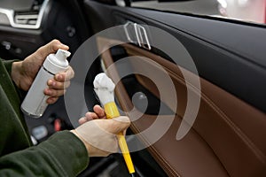 Auto dateline service worker using professional cosmetics for car cleaning