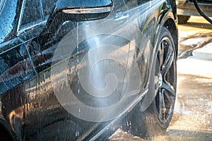 Auto detailer washing luxury high end car