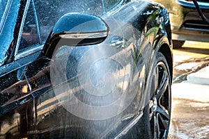 Auto detailer washing luxury high end car