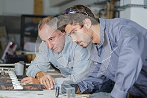 Auto electrical workers in garage