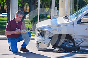 Auto insurance adjuster inspecting accident claim photo